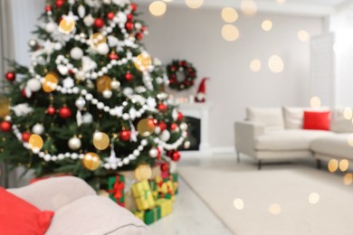 Photo of Blurred view of beautiful Christmas tree in stylish living room interior. Bokeh effect