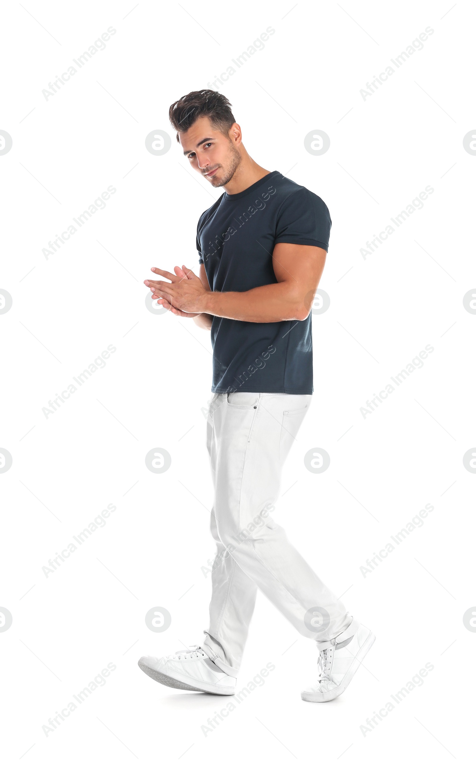 Photo of Young man in stylish jeans on white background