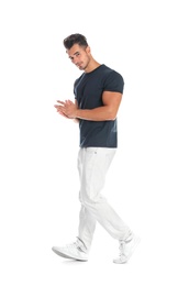 Young man in stylish jeans on white background