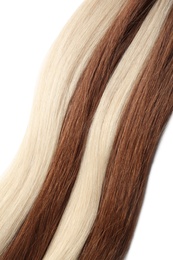 Photo of Strands of different color hair on white background