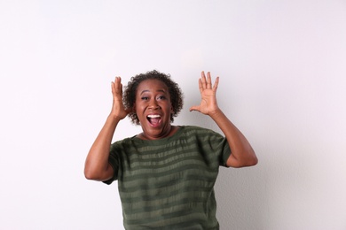 Photo of Portrait of happy African-American woman on white background