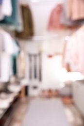 Photo of Blurred view of modern dressing room with stylish clothes