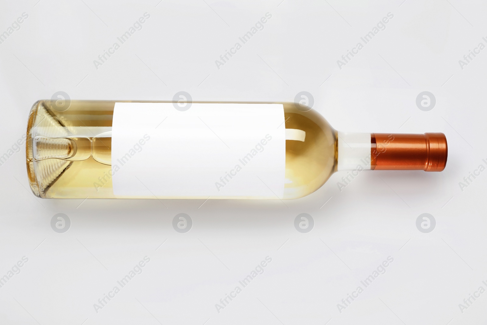 Photo of Bottle of delicious wine with blank label on white background