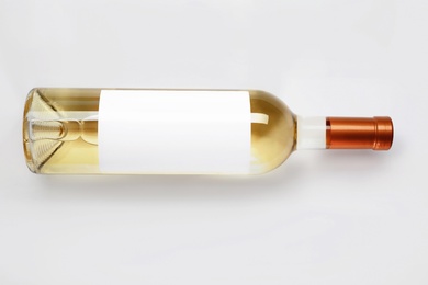 Bottle of delicious wine with blank label on white background