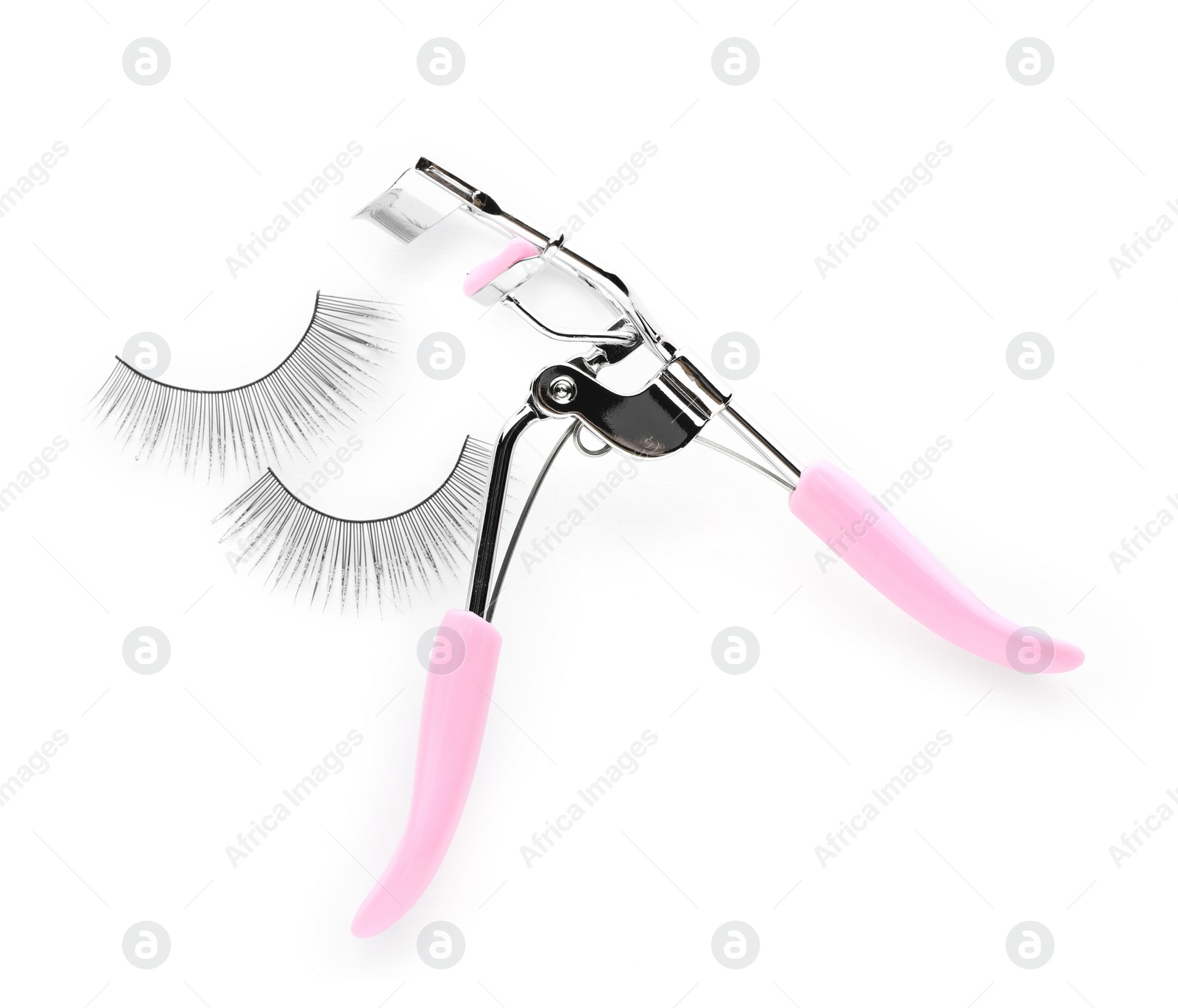 Photo of Fake eyelashes and curler on white background, top view