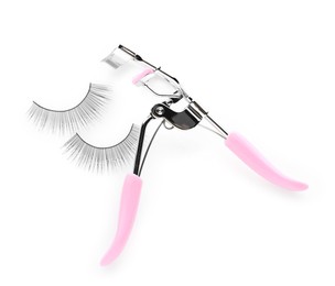 Photo of Fake eyelashes and curler on white background, top view