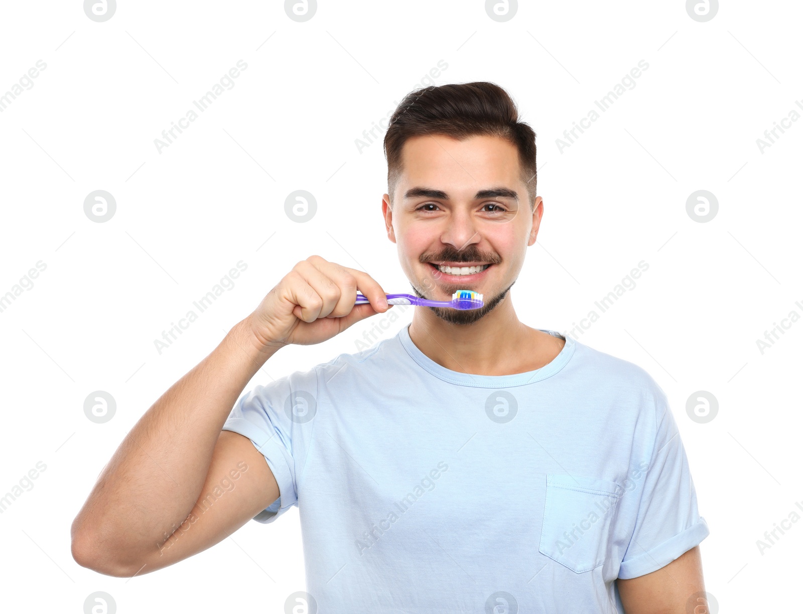 Photo of Young man brushing teeth on white background