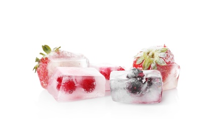 Photo of Fresh berries frozen in ice cubes on white background