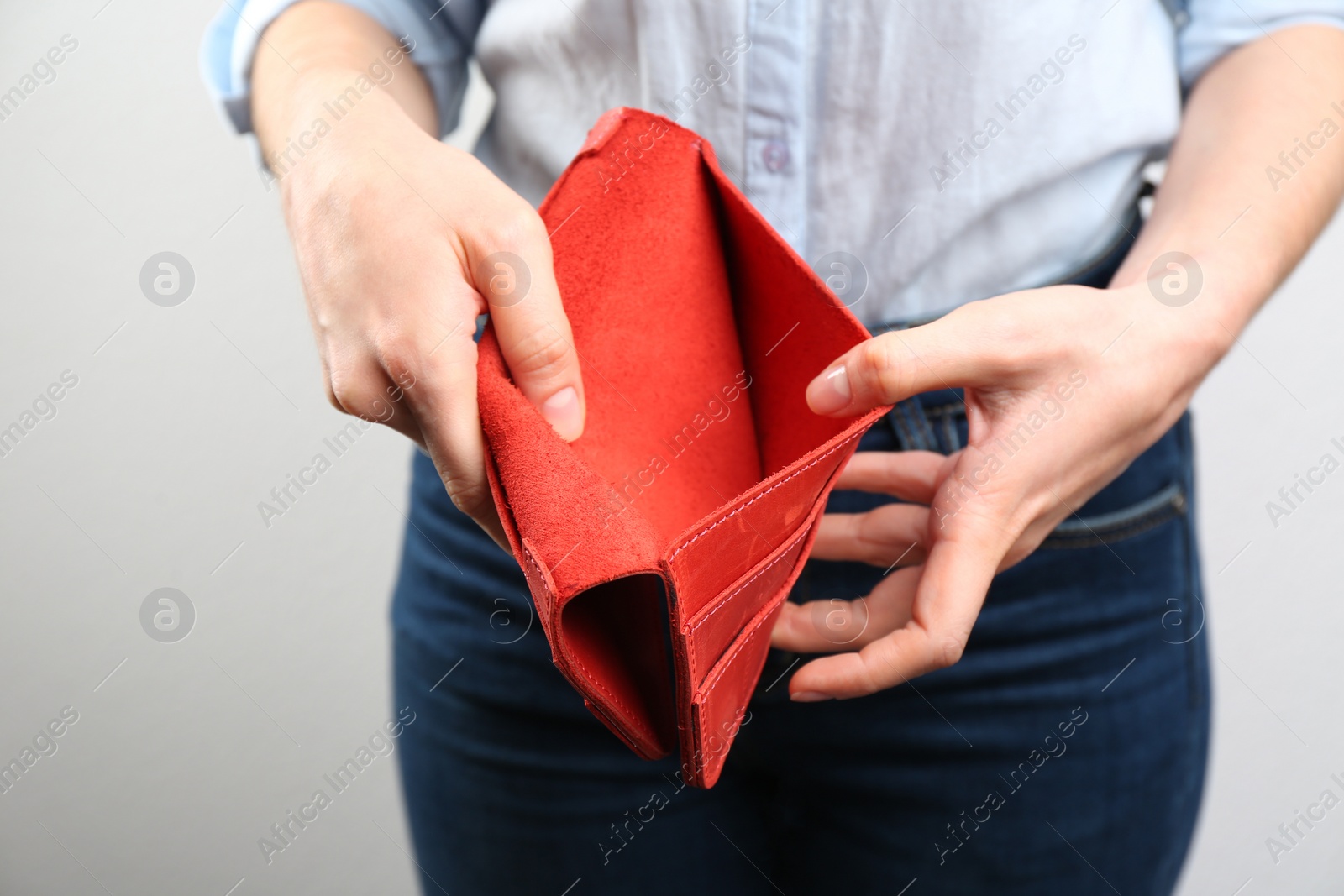 Woman showing empty wallet on light background, closeup Photo of Woman showing empty wallet on light background, closeup
