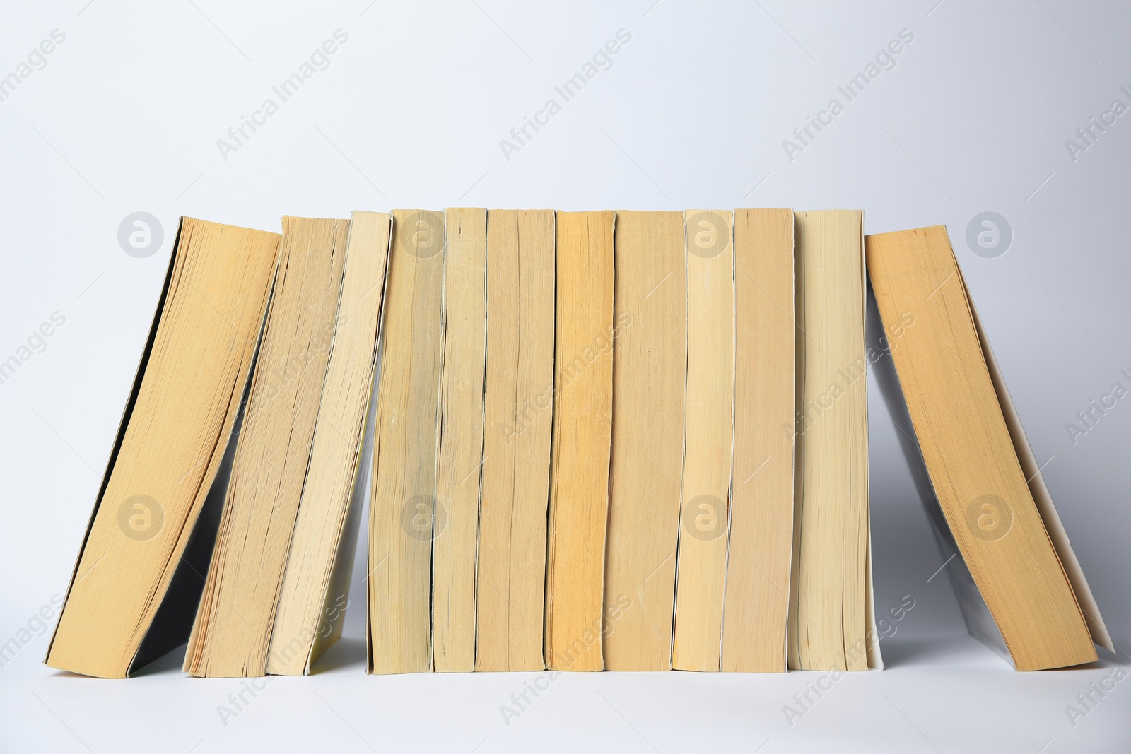 Photo of Collection of different books on light background