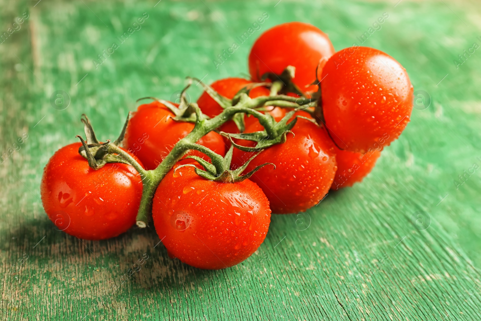 Photo of Fresh ripe red tomatoes on wooden table