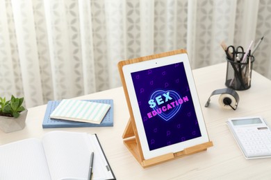Image of Sex education. Modern tablet computer with open program on table