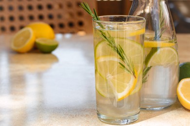 Photo of Summer refreshing lemonade on light table in cafe, space for text