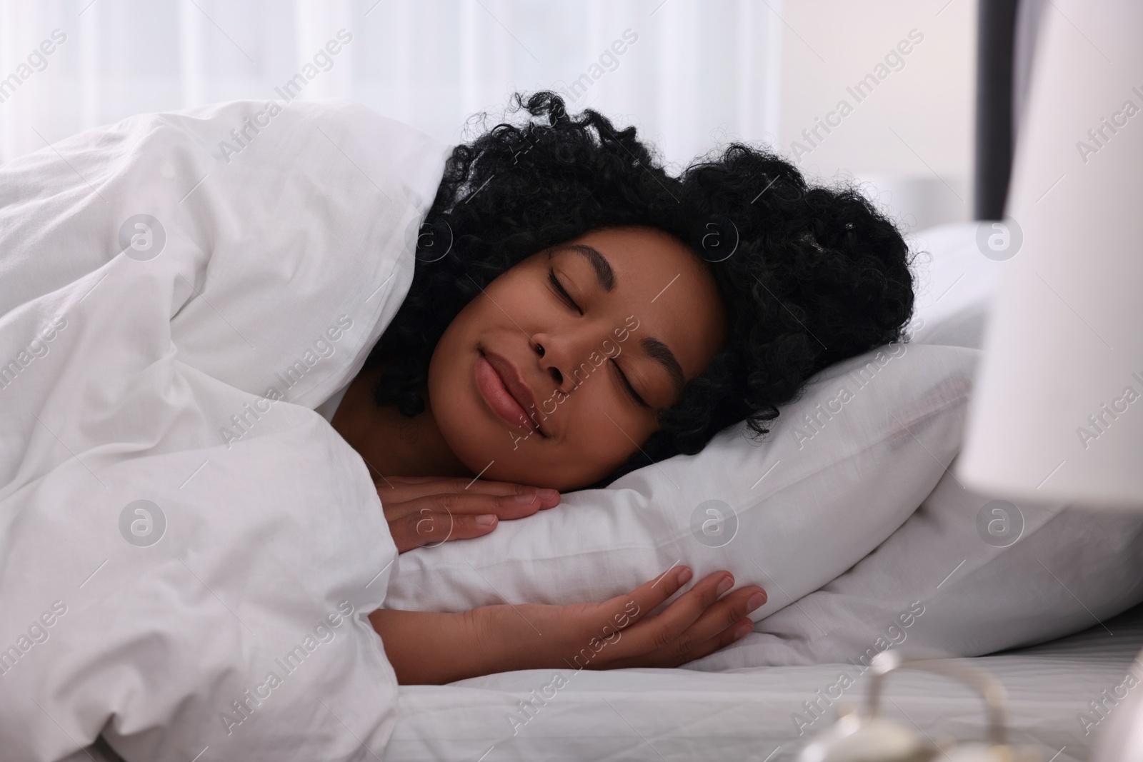 Photo of Beautiful young woman sleeping in soft bed