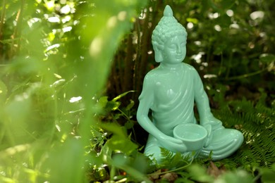 Decorative Buddha statue outdoors. Space for text