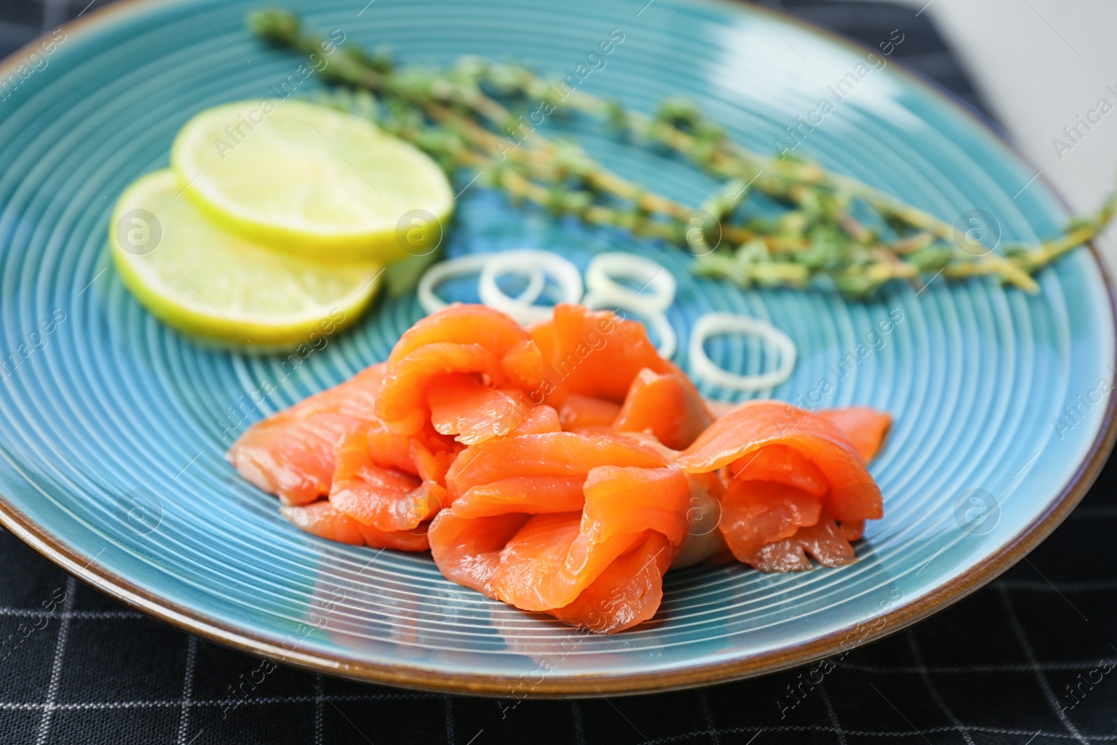 Photo of Plate with fresh sliced salmon fillet, closeup