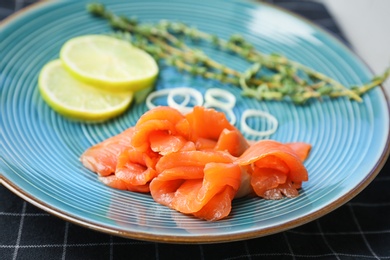 Photo of Plate with fresh sliced salmon fillet, closeup