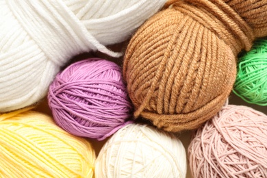 Photo of Soft colorful woolen yarns as background, closeup