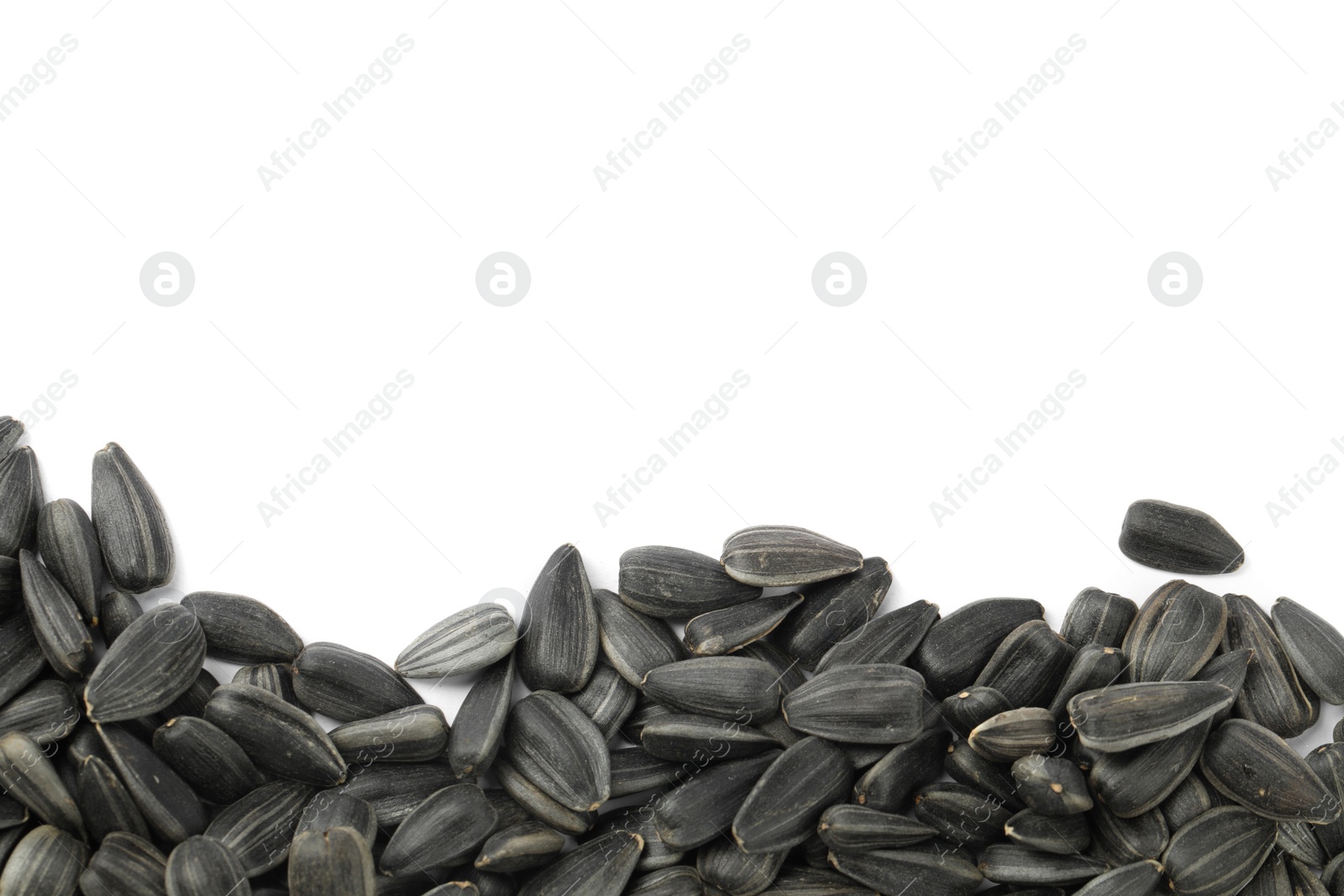 Photo of Raw sunflower seeds on white background, top view