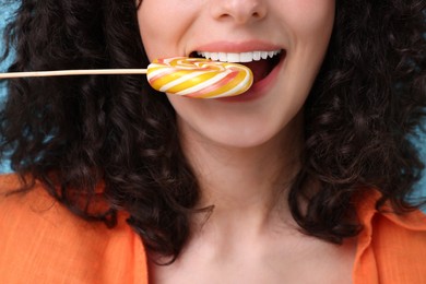 Woman with tasty colorful lollipop, closeup view