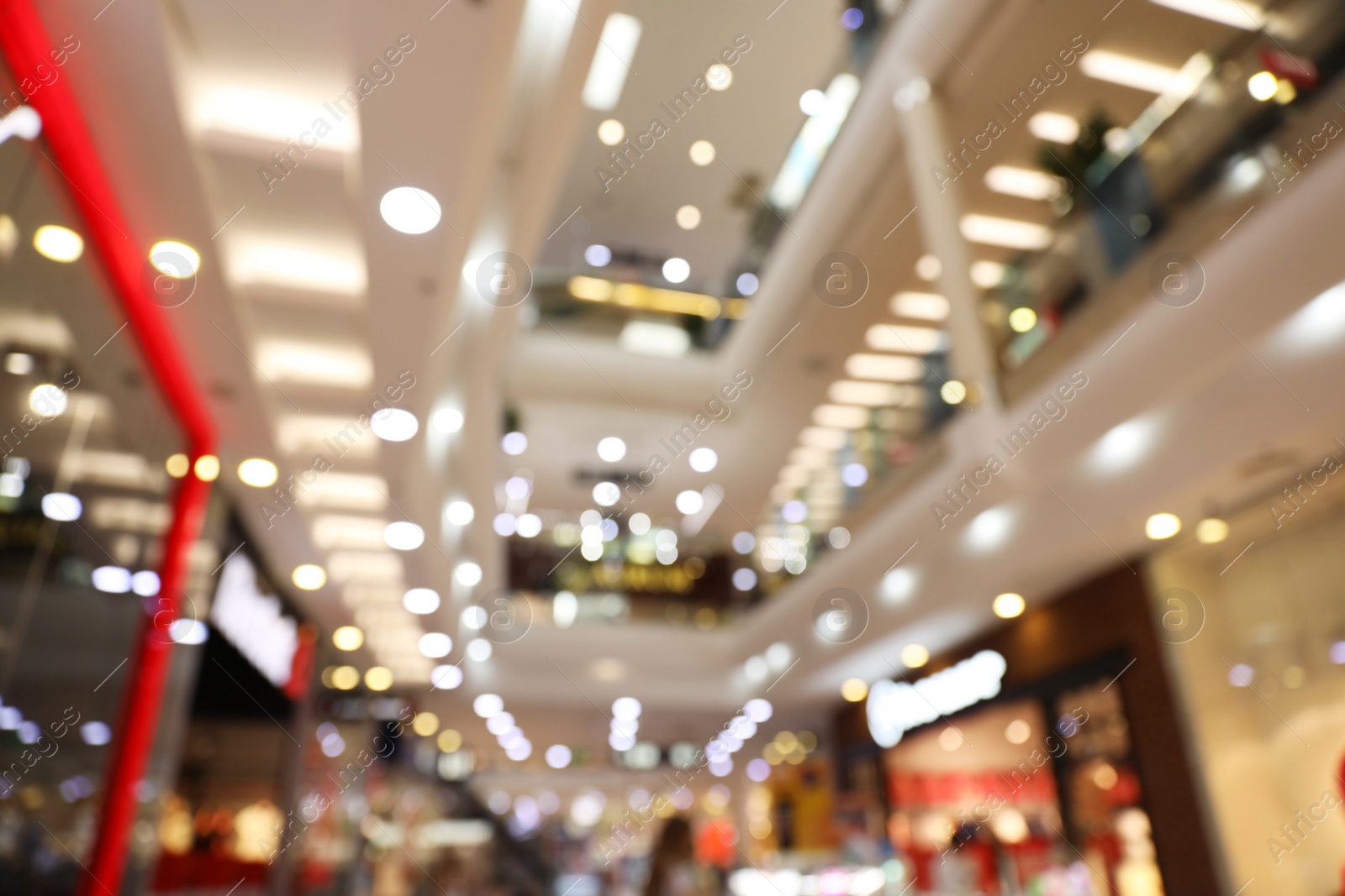 Photo of Blurred view of modern shopping mall interior. Bokeh effect