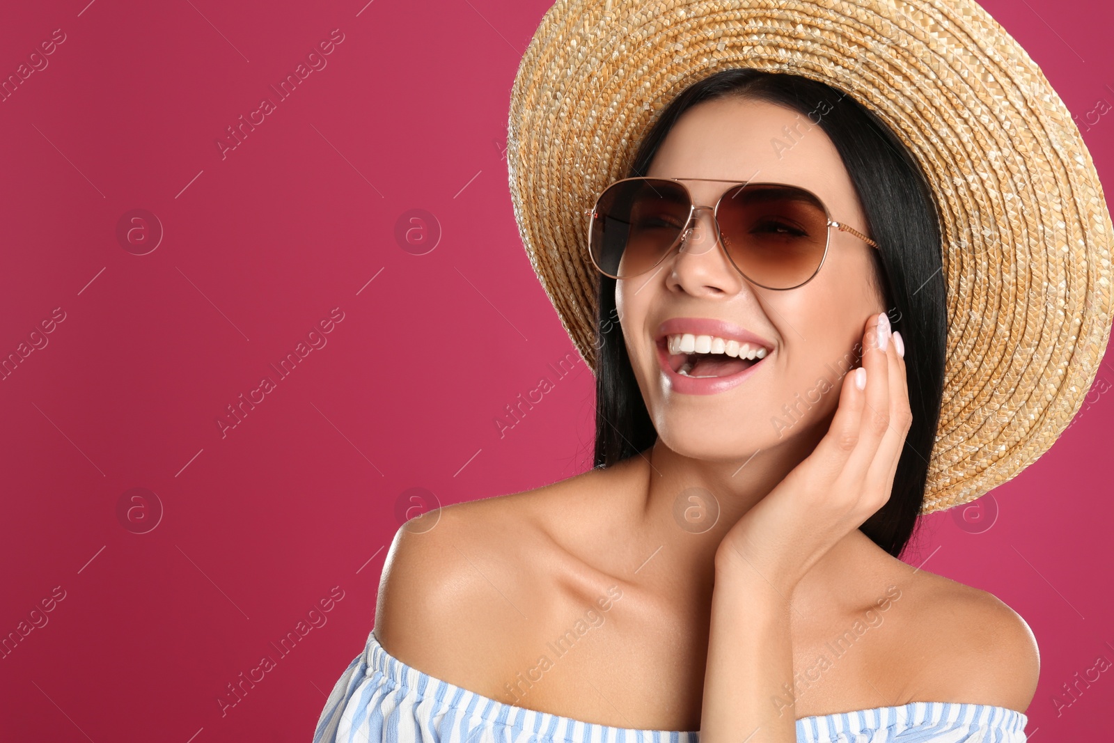 Photo of Beautiful woman wearing sunglasses on pink background