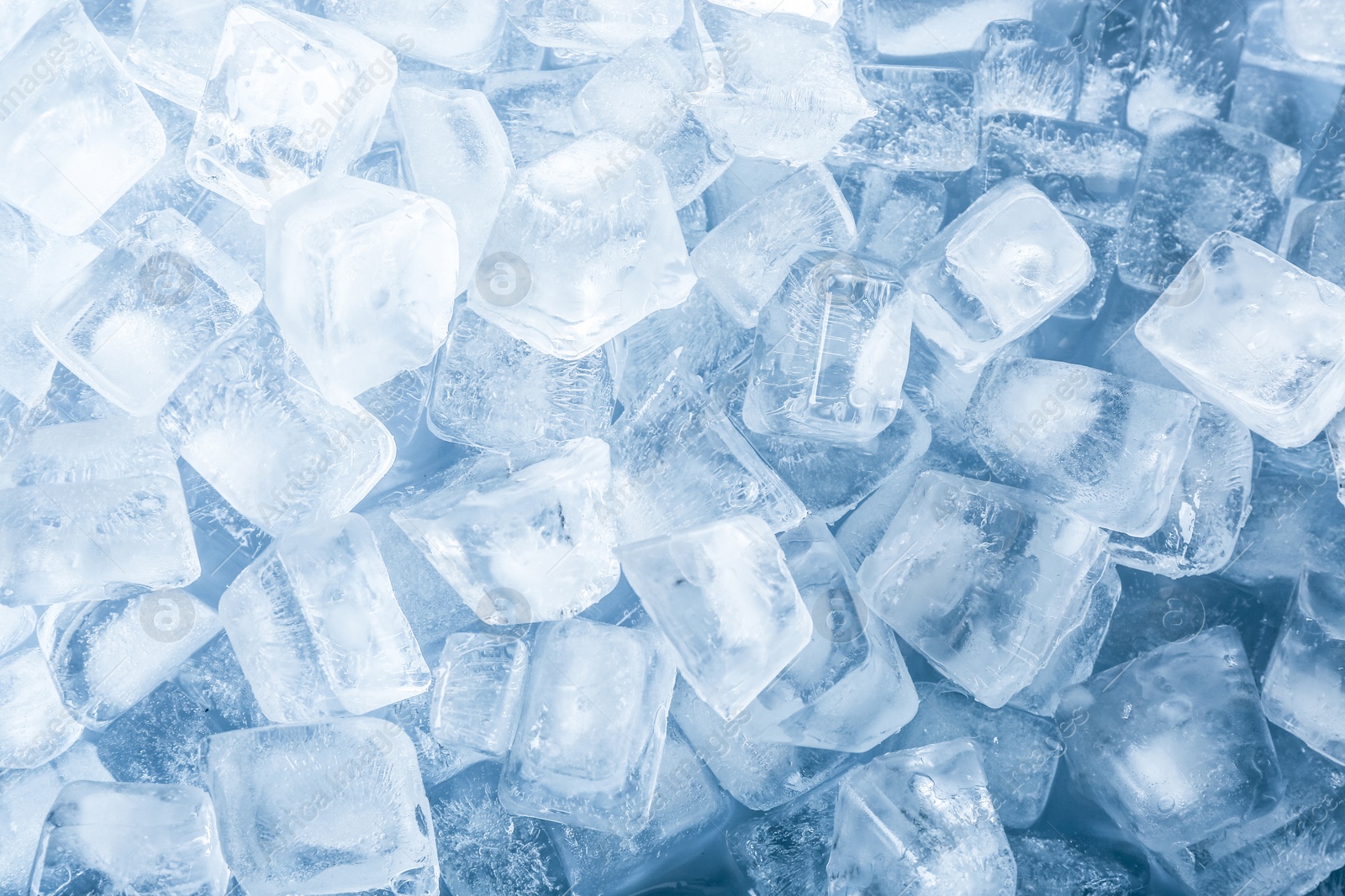 Photo of Crystal clear ice cubes as background, top view
