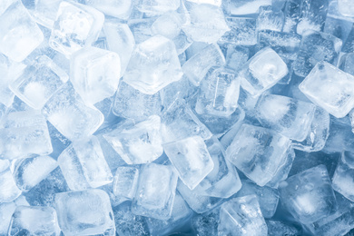 Photo of Crystal clear ice cubes as background, top view