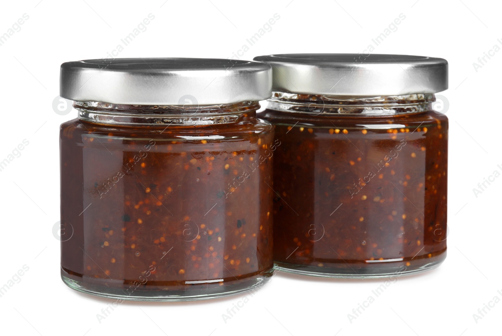 Photo of Glass jars of tasty sweet fig jam isolated on white