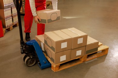 Image of Worker sorting cardboard boxes in warehouse, closeup. Logistics concept