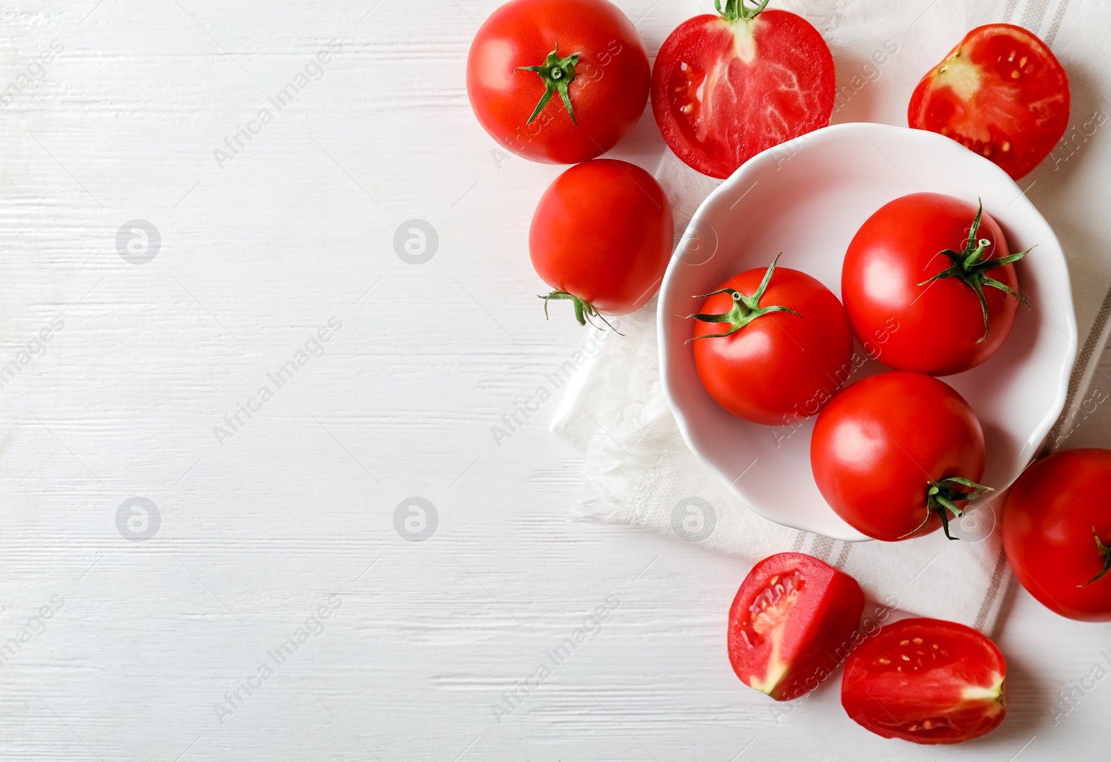 Photo of Fresh ripe tomatoes on white wooden table, flat lay. Space for text