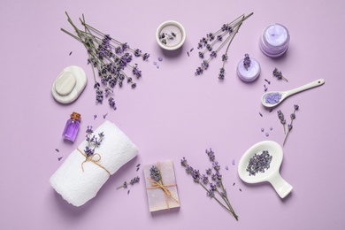 Photo of Cosmetic products and lavender flowers on lilac background, flat lay. Space for text