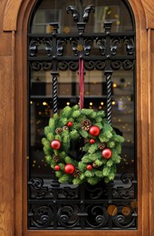 Beautiful Christmas wreath hanging on wooden door