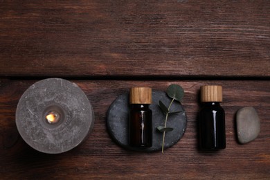 Flat lay composition with spa products and eucalyptus branch on wooden table. Space for text