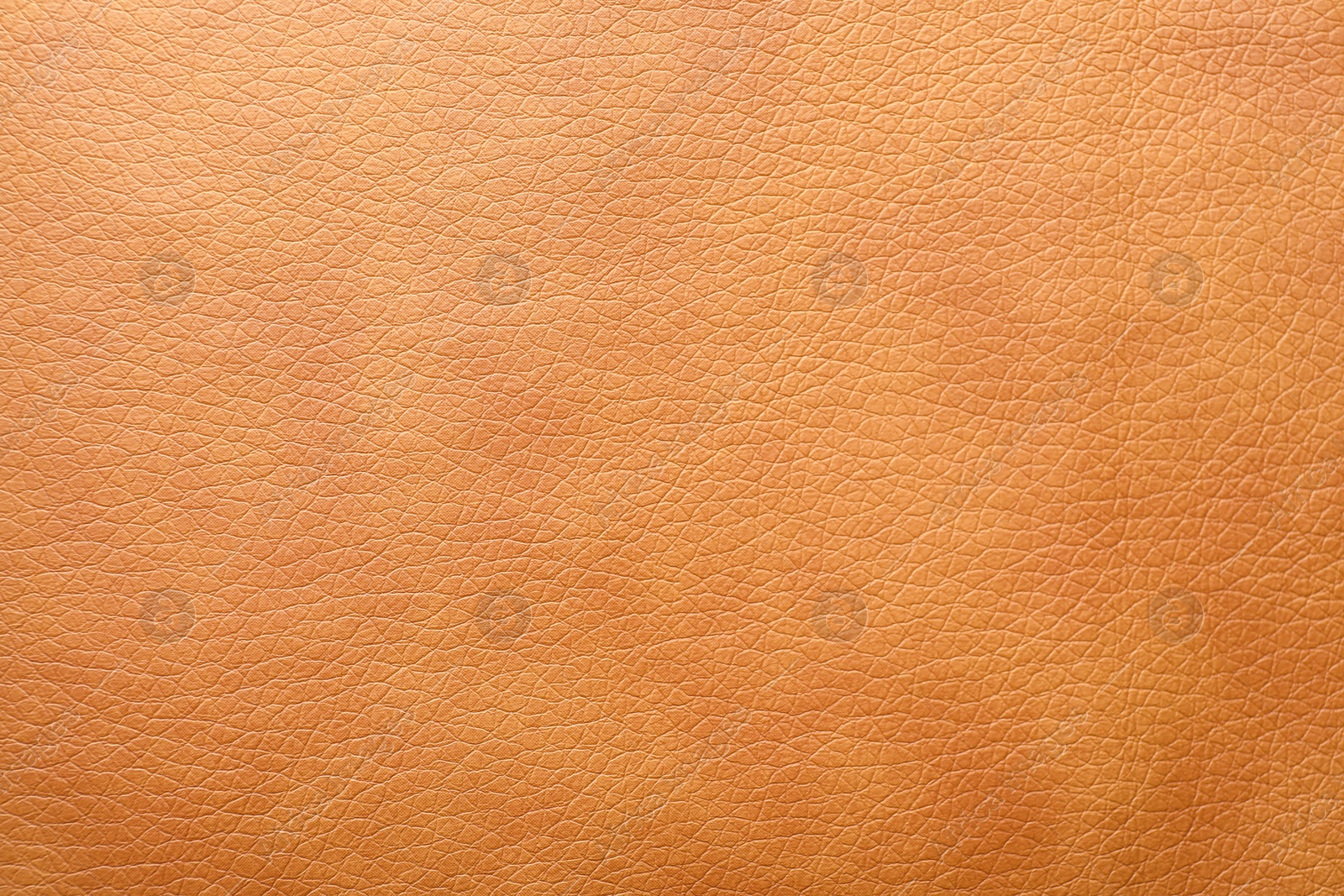 Photo of Texture of orange leather as background, closeup