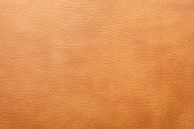Photo of Texture of orange leather as background, closeup