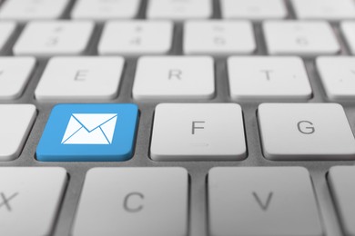 Email. Light blue button with illustration of envelope on computer keyboard, closeup