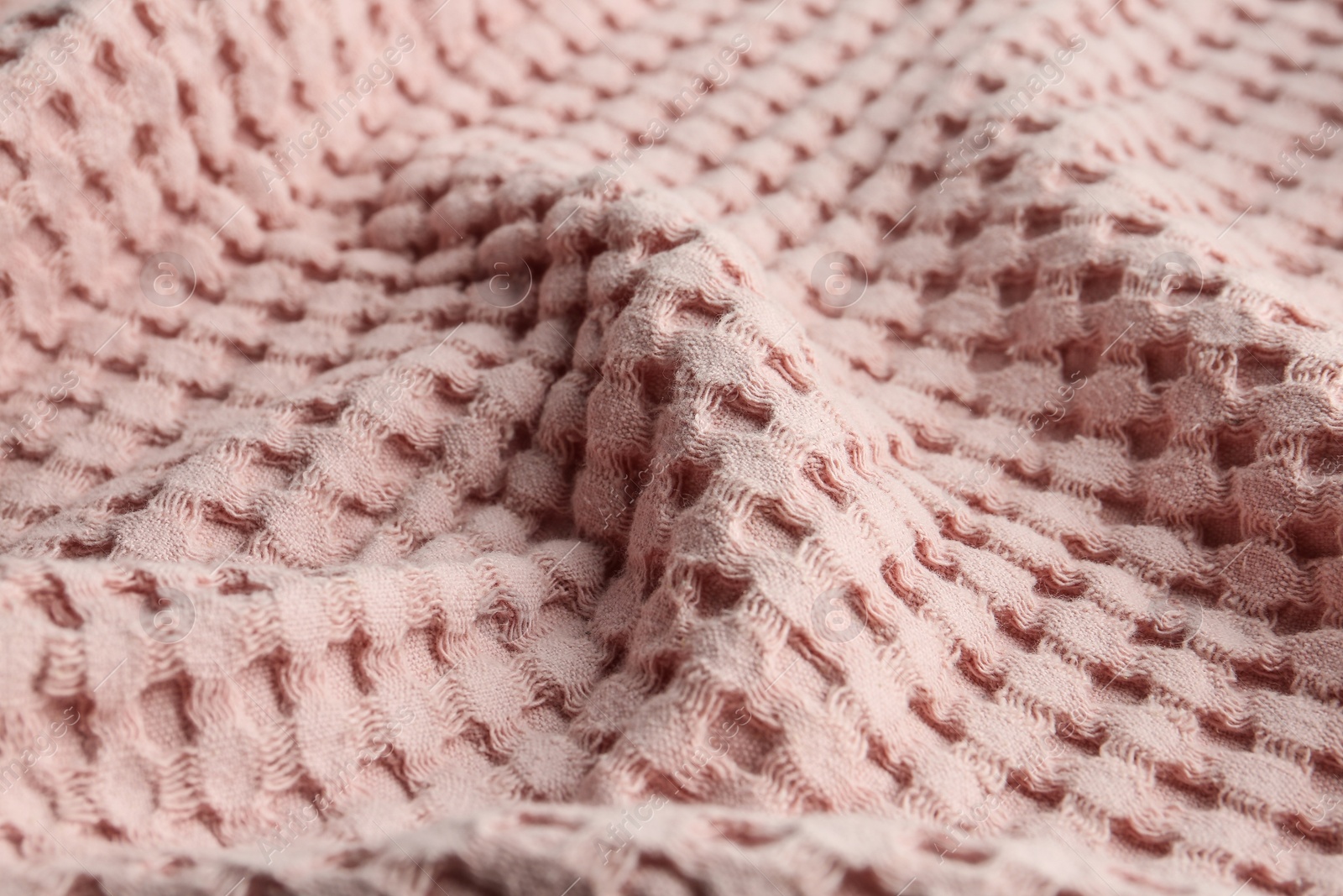 Photo of Texture of soft light pink fabric as background, closeup