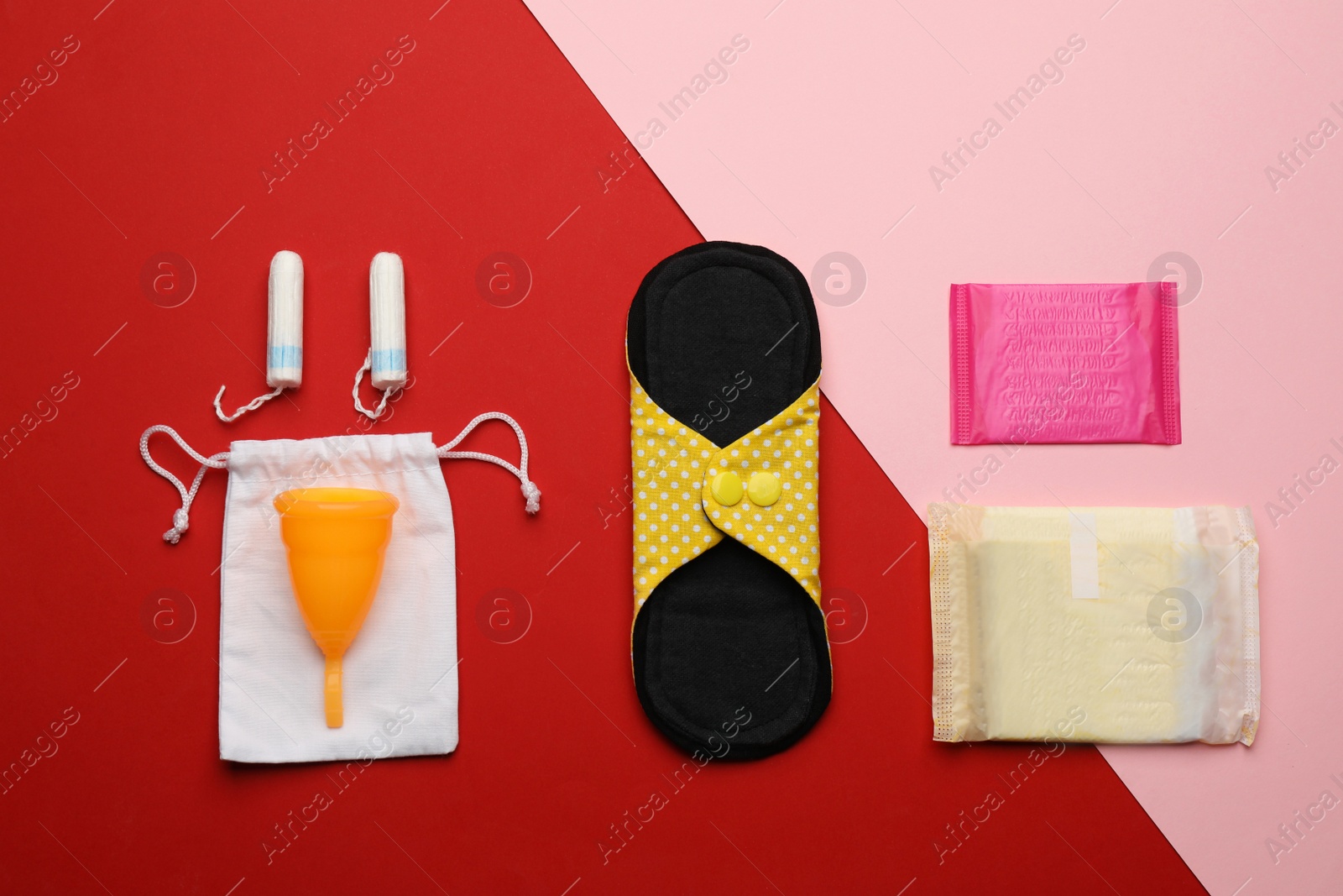 Photo of Cloth menstrual pad near other reusable and disposable female hygiene products on color background, flat lay