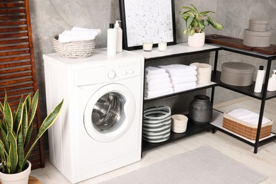 Stylish laundry room with modern washing machine. Interior design