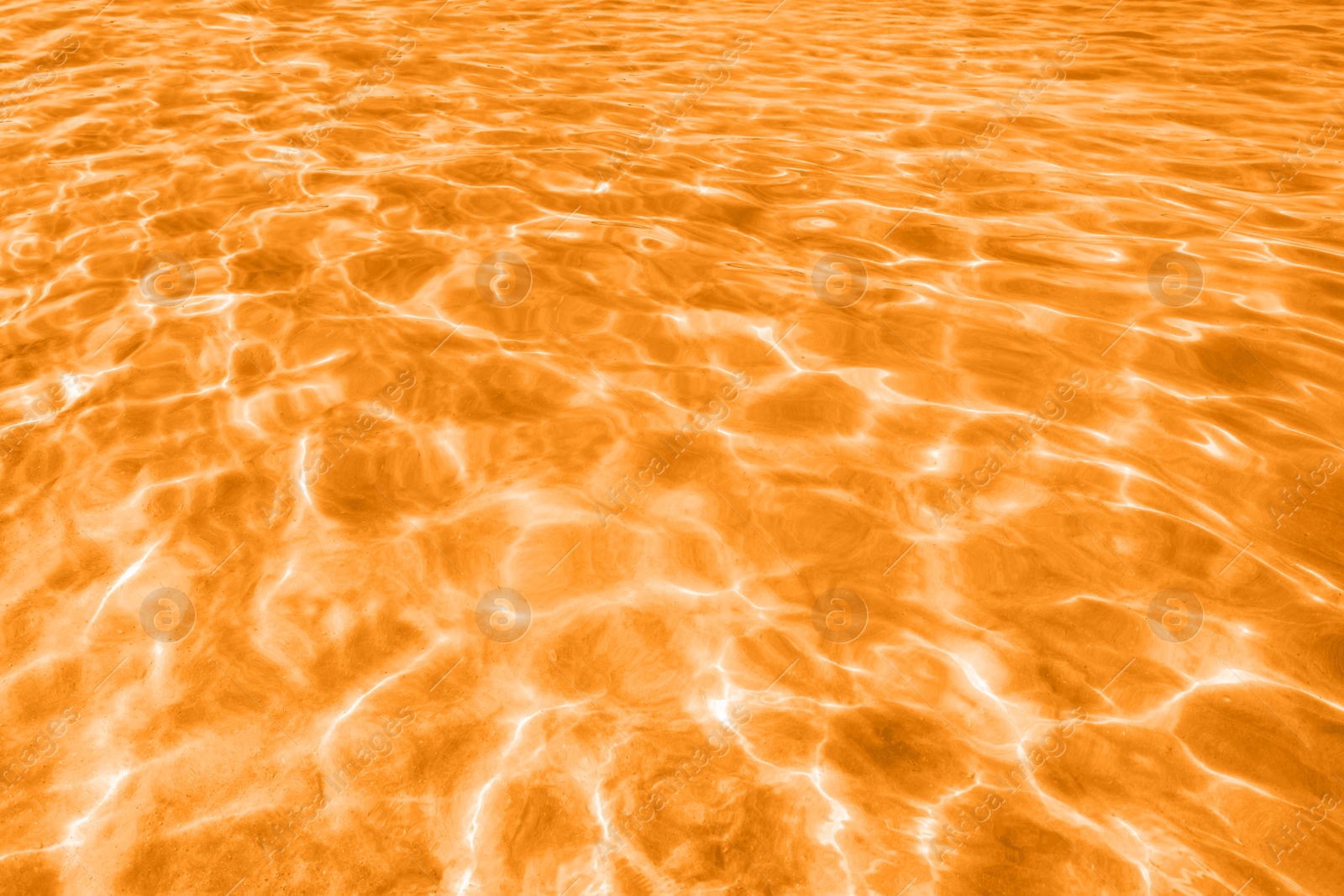 Image of View on ocean water with ripples and flecks. Toned in orange
