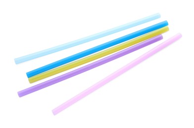 Photo of Color plastic cocktail tubes on white background