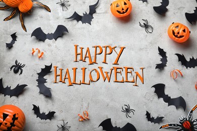 Image of Happy Halloween. Frame made with decor elements on light grey background, flat lay