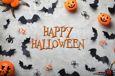 Happy Halloween. Frame made with decor elements on light grey background, flat lay