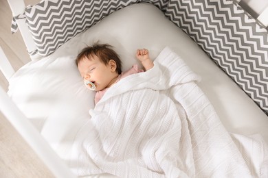 Photo of Cute little baby sleeping on cosy bed