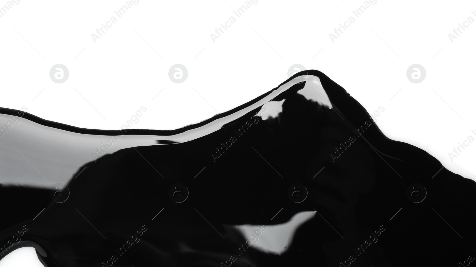 Photo of Black glossy paint spilled on white background, top view