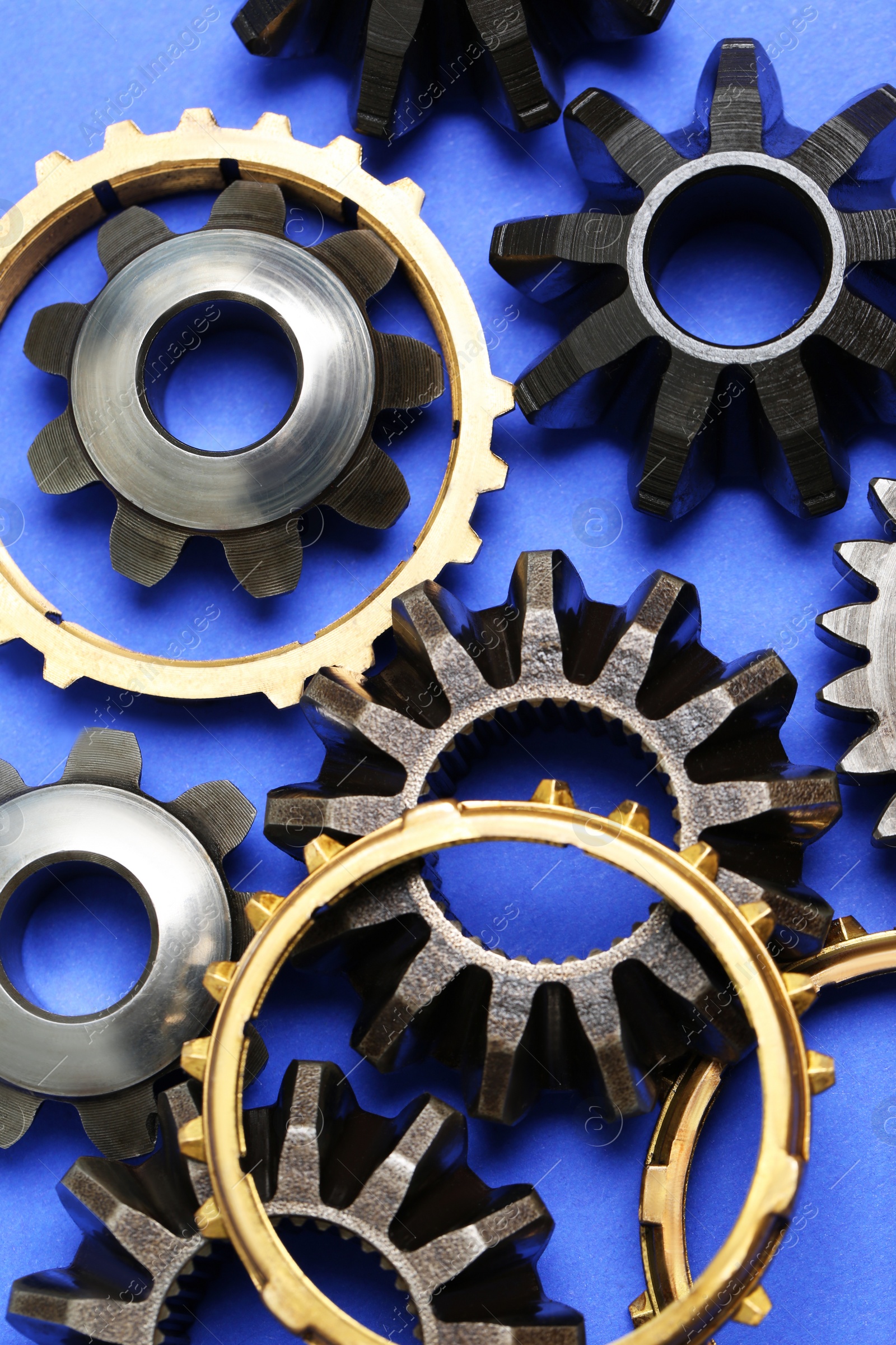 Photo of Different stainless steel gears on light blue background, flat lay
