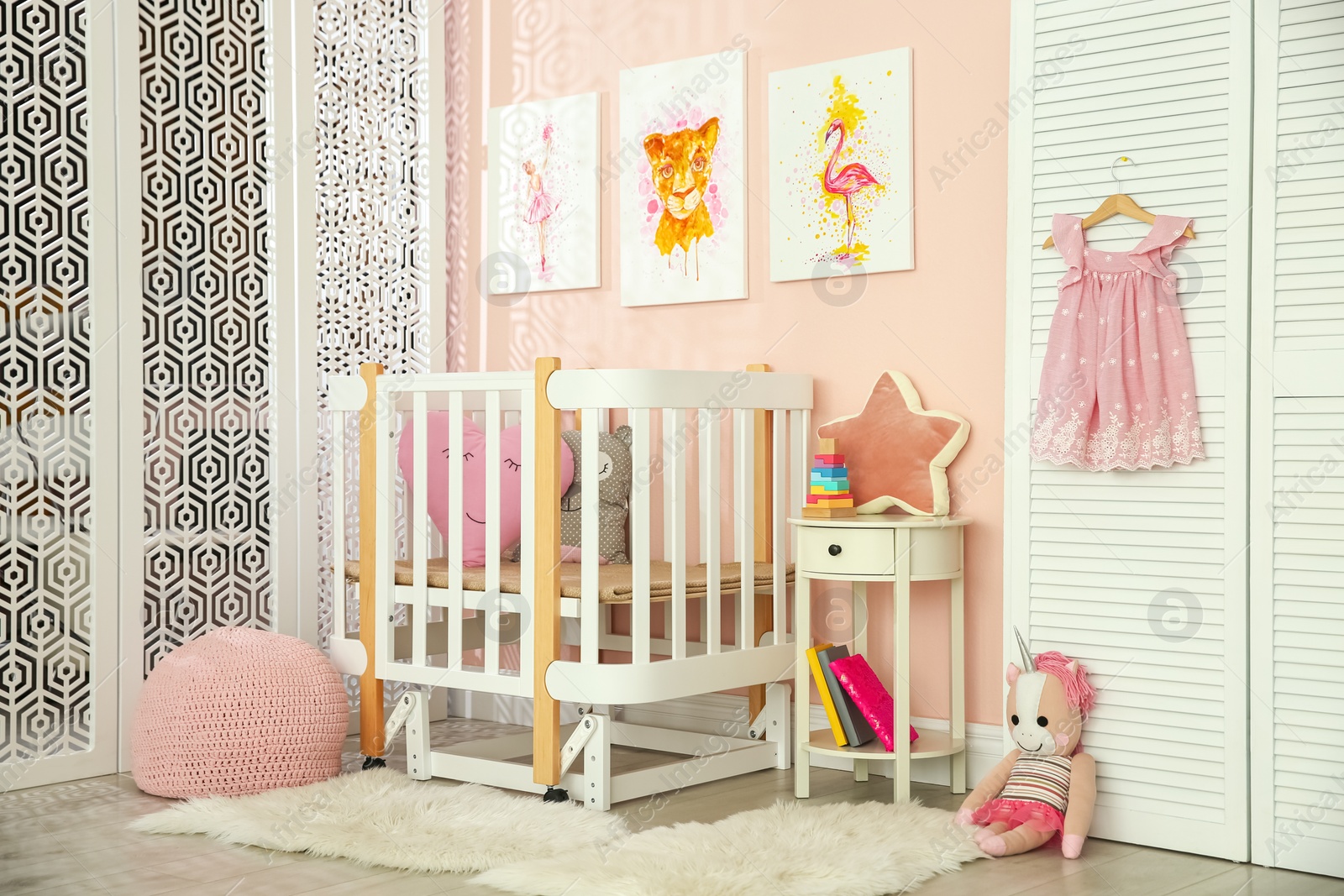 Photo of Cute pictures and crib in baby room interior