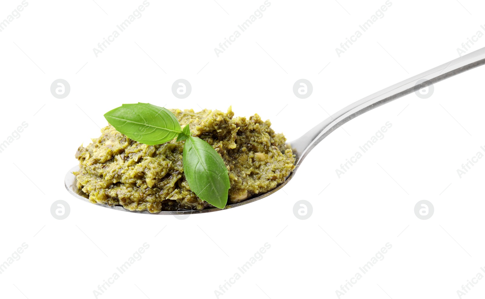 Photo of Spoon with delicious pesto sauce and basil isolated on white