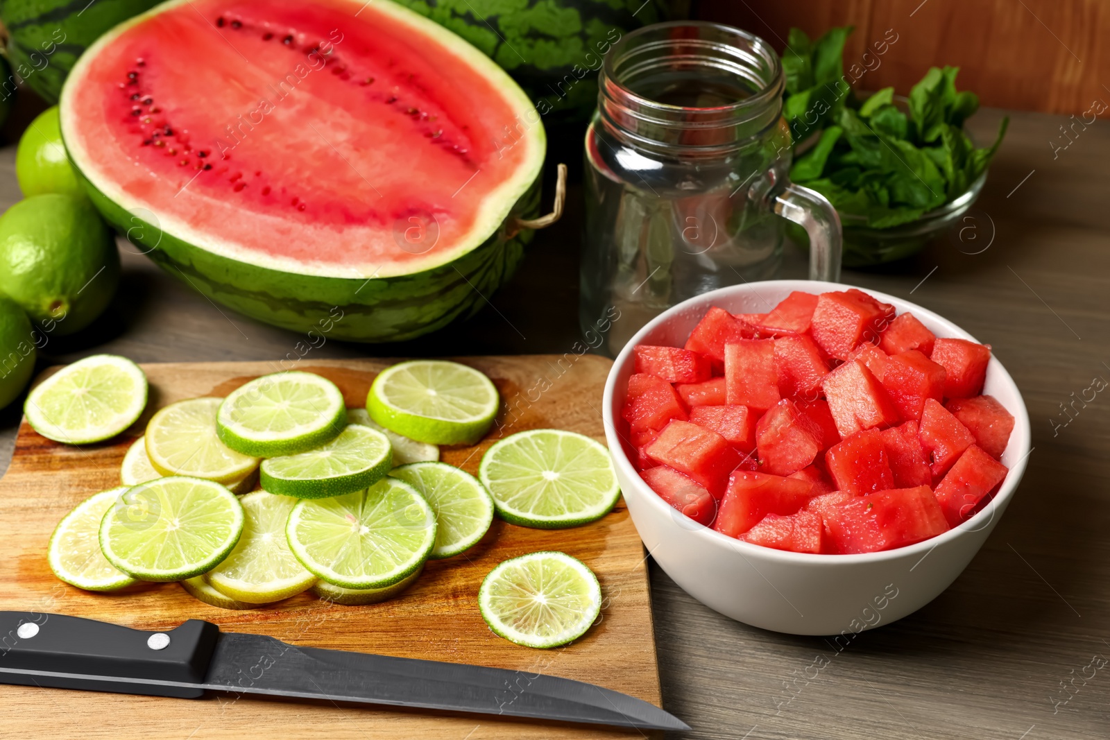 Photo of Fresh ingredients for making watermelon drink with lime on wooden table